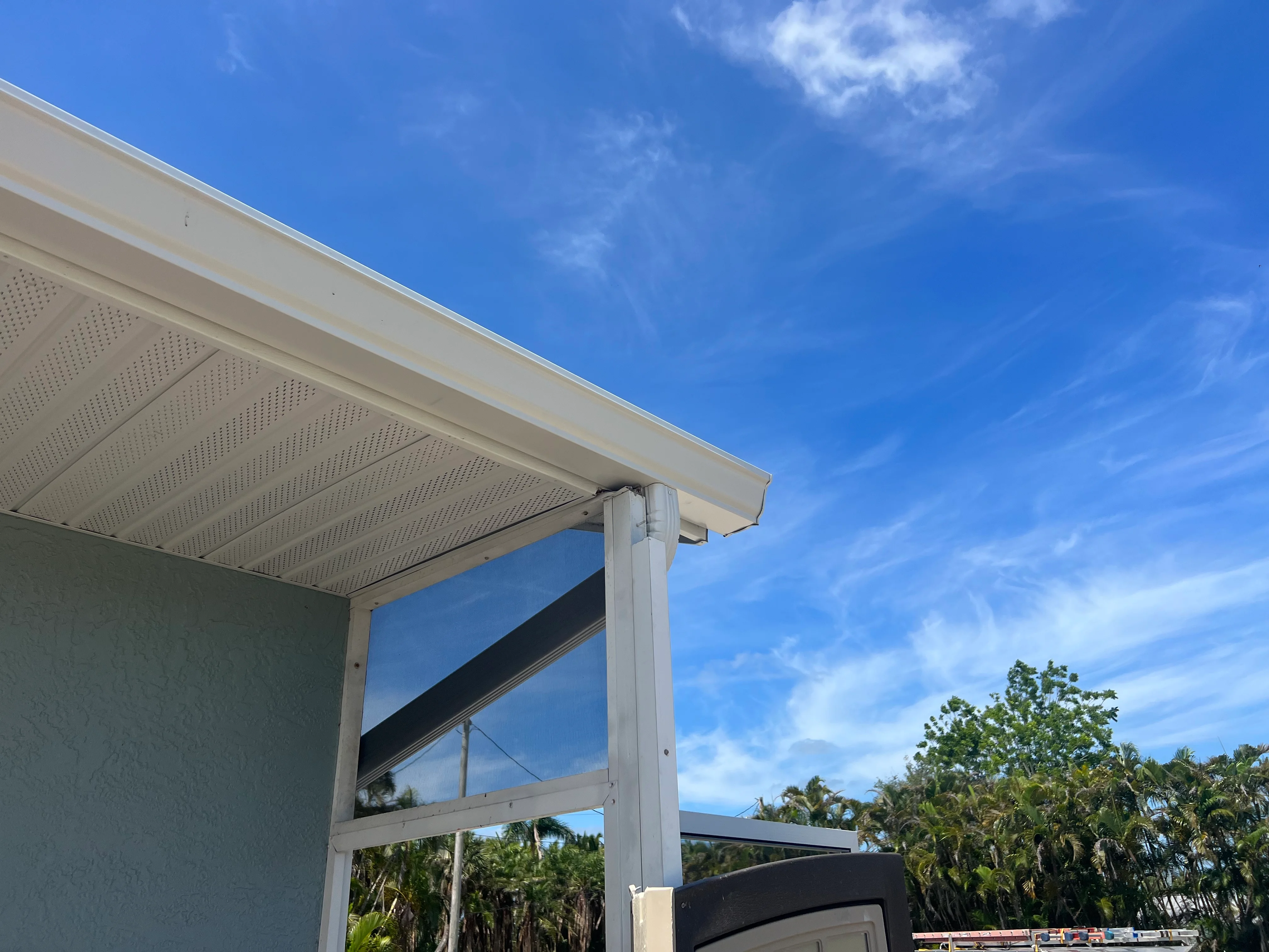 White aluminum patio cover with perforated soffit and integrated gutter system